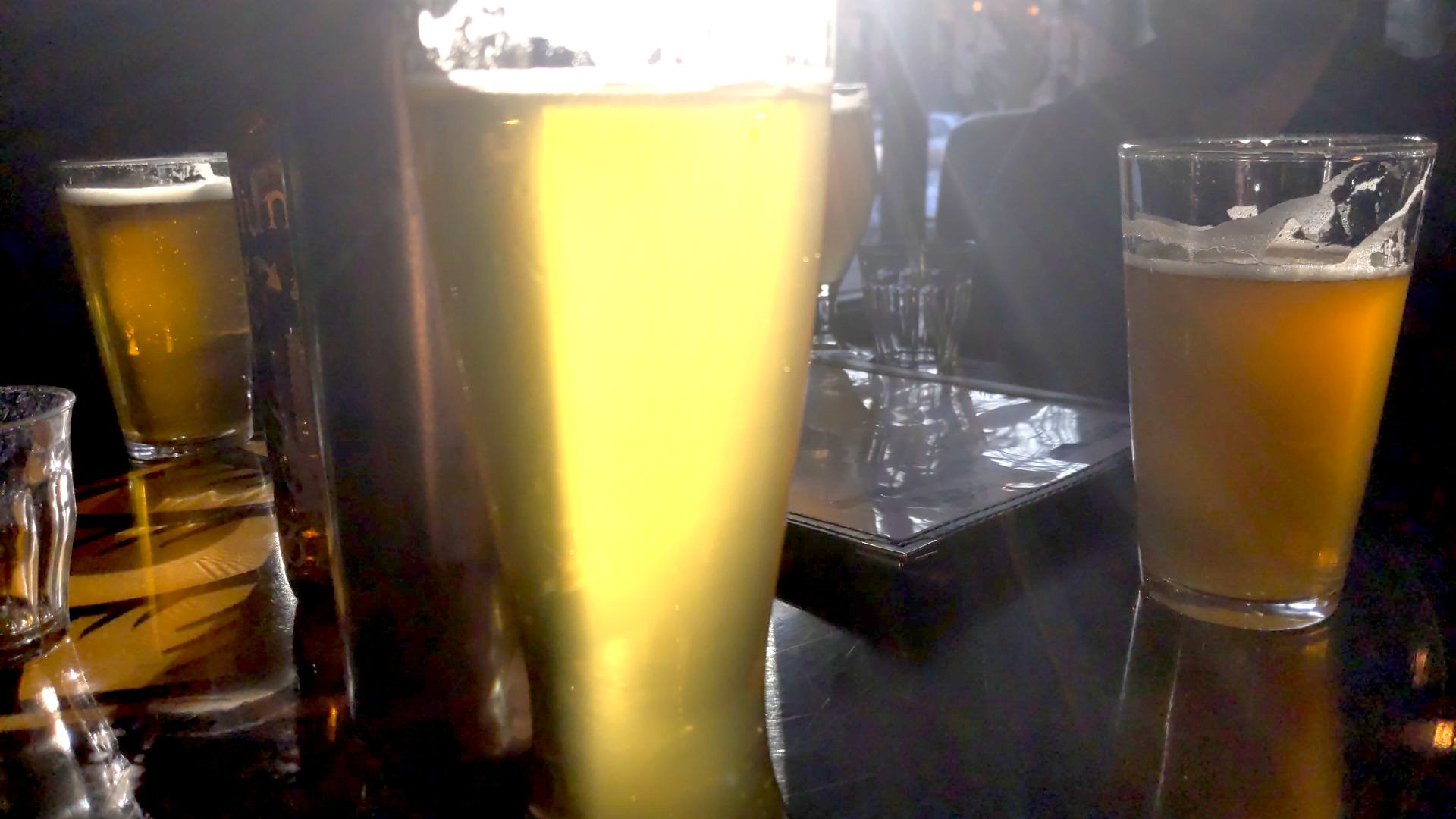 A glass of beer illuminated by sunlight